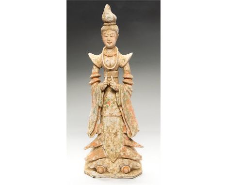 Chinese Tang Dynasty Female Courtier in Elaborate Dress, 618-907 AD  A ceramic tomb figure of a female courtier, hair pulled 