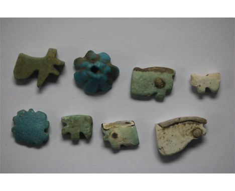 Egyptian Amulet Group, Late Period, 664-332 BC.&nbsp; A group of faience amulets consisting of six Eye of Horus; a lotus flow
