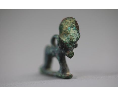Egyptian Apis Bull Amulet, Late Period, 664-332 BCA bronze amulet of the Apis bull, standing on a rectangular base, with sun-