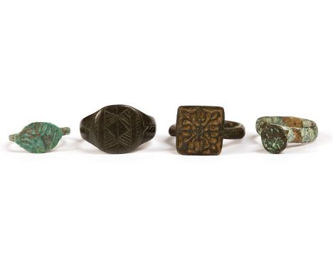 Signet Ring Group, 17th century AD.  A group of four bronze rings, the bezels engraved with stylised flowers.Ex. Gloucestersh