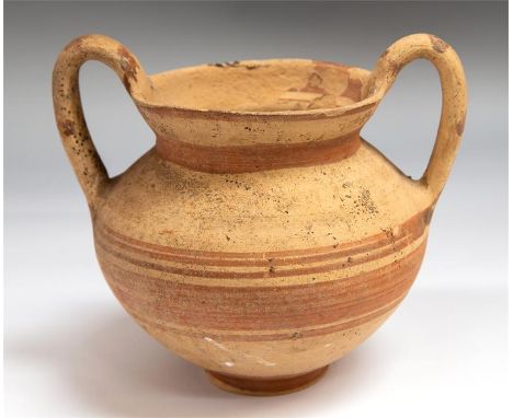 Greek pottery two handled vase circa 4th or 3rd century BC.   A buff Messapian two handled kantharos from the Greek south Ita