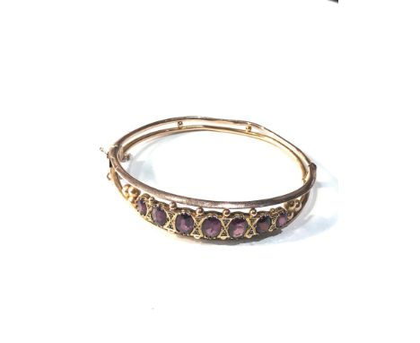 9ct gold almandine garnet bangle w/ Chester hallmark weight 9.1g age related wear marks and creases 