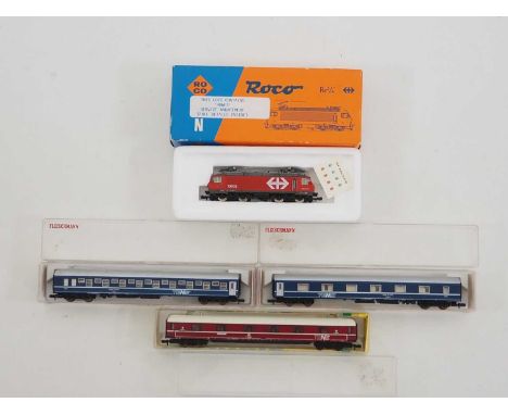 A group of ROCO, MINITRIX and FLEISCHMANN Swiss outline N gauge rolling stock comprising a Re 4/4 IV class electric locomotiv