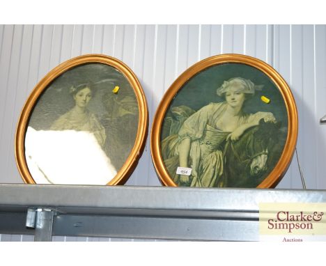 A pair of gilt framed oval portrait prints 