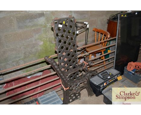 A pair of cast iron bench ends and back