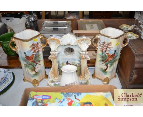 A china clock case decorated with pheasants; a pair of similar vases decorated with pheasants and an Axe Vale pottery vase