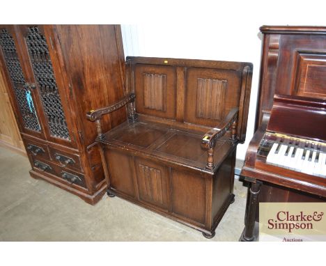 A linen fold decorated monks bench 
