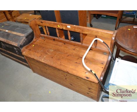 A pine bench with under seat storage