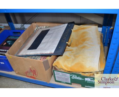 Two boxes of various linen to include tapestry wall hanging, fabric swatch book etc.