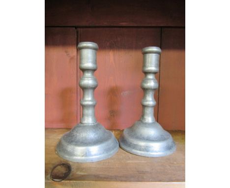 A pair of 18th Century pewter candlestick with pushers and domed bases, baluster stems, 14.5 cm tall 