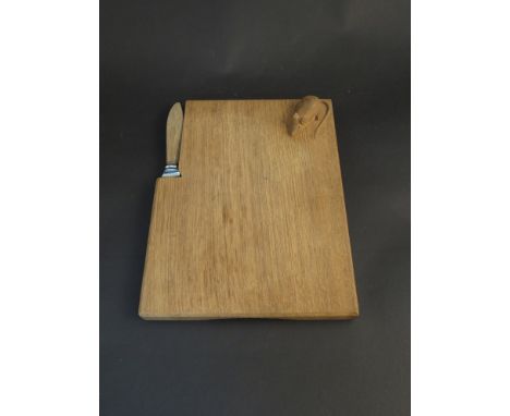 A Mouseman oak cheese board, 22.5cm long