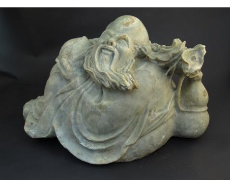 A large 19th Century Chinese soapstone boulder carving of a sage holding a gourd.  45cm long 