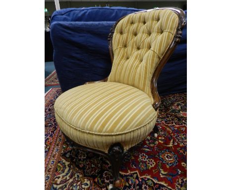 A Victorian walnut spoon back nursing chair on cabriole front legs later covered in a striped gold plush fabric