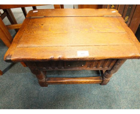 A 20th century oak hinge lid box stool in the 17th century style 