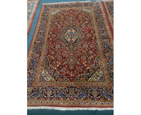 A modern red ground Persian design carpet, approximately 305cm x 204cm