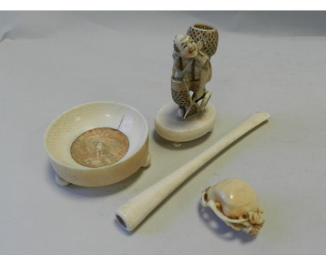 A Japanese ivory Netsuke, carved with a man holding a basket, 5cm high, signed, early 20th century, together with another bon