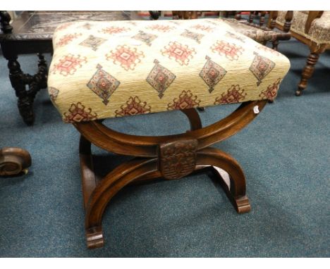 A Victorian Gothic revival X-frame dressing stool with later covered overstuffed seat pad 