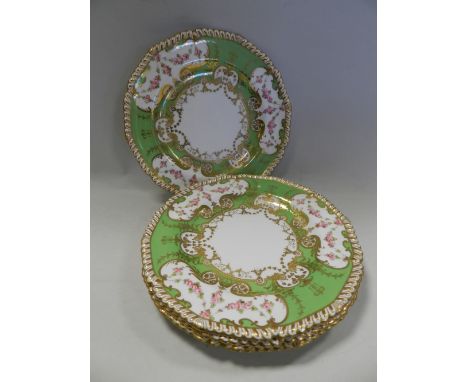 Four Royal Crown Derby dessert plates dated 1907, decorated with flower swags with in a green and gold border.