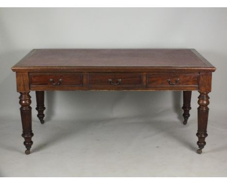 A late Victorian mahogany partners desk, the rectangular bevelled top with inset red leather skiver above three frieze drawer