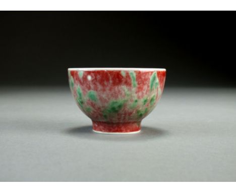 A Chinese 'peach bloom' teabowl, Kangxi six-character mark but later, of plain rounded form and decorated with a mottled glaz