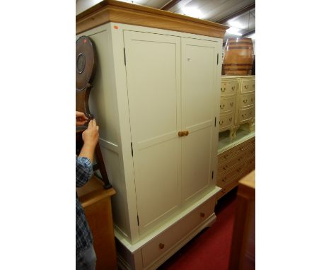 A contemporary light oak and white painted double door wardrobe having single long lower drawer, width 111cm