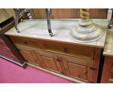 A contemporary pine low sideboard, having twin frieze drawers, w.132cm; together with a matching kneehole dressing table (2)