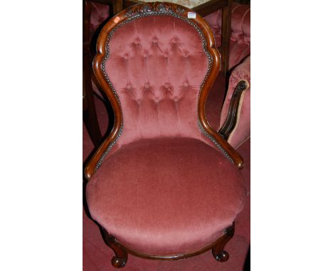 A Victorian walnut framed and pink button back and further studded upholstered nursing chair