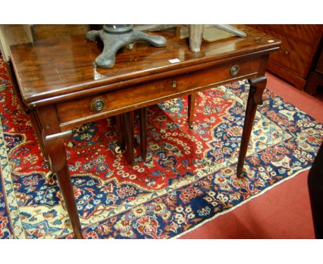 A George III mahogany fold over card table having twin rear gate leg action, single frieze drawer to pad feet, width 92cm