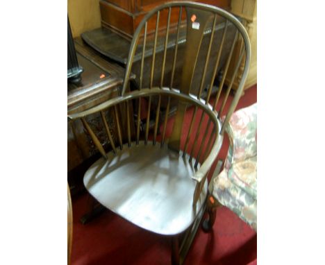 A contemporary Ercol dark elm stick back rocking armchair