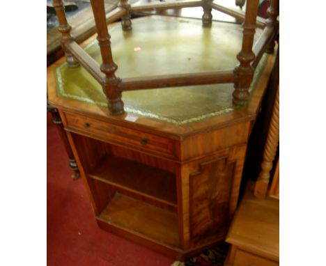 A Regency style mahogany and flame mahogany, green leather inset book table, of octagonal chamfered form, with opposing friez