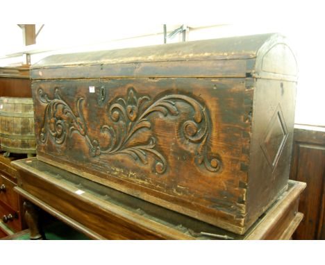 A 19th century Italian stained pine hinged dome top blanket box having floral carved front panel, width 113cm
