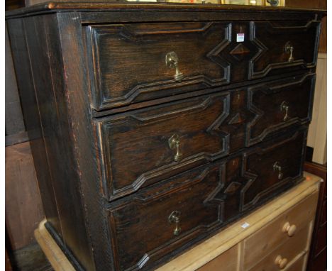 An early 20th century Jacobean style moulded oak chest of three long drawers, width 107cm