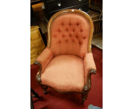A mid Victorian mahogany gentleman's spoonback armchair having red floral button back upholstery