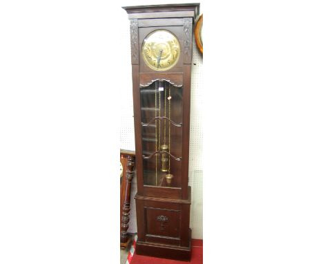 A 1930s oak three train long case clock, having a circular brass dial with glazed trunk door with pendulum and two weights (o