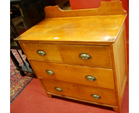 An Edwardian light oak ledgeback chest, of two short over two long drawers, w.92cm