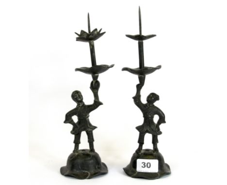 A pair of Oriental bronze figural candlesticks, H. 26cm.