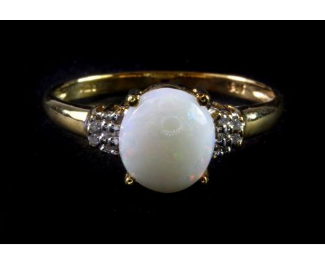 A 9ct yellow gold ring set with cabochon cut opal and diamonds, (O.5).