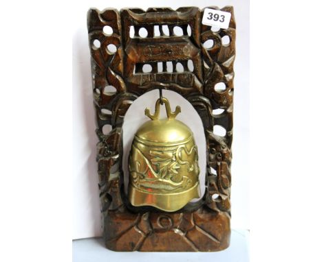 A Burmese hardwood and bronze bell, H. 37cm.