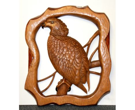A carved wooden panel of an eagle, 44 x 52cm.
