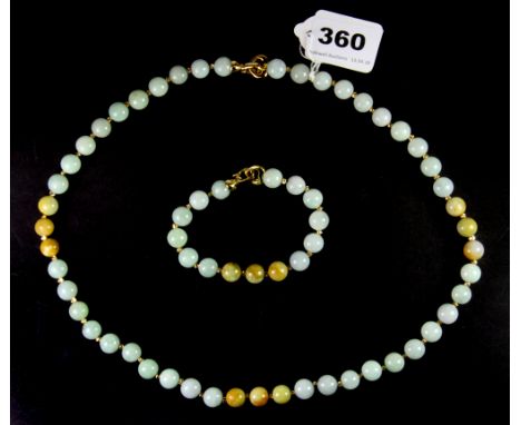 A necklace and matching bracelet of mixed coloured jade beads with gilt clasps, necklace length 60cm.