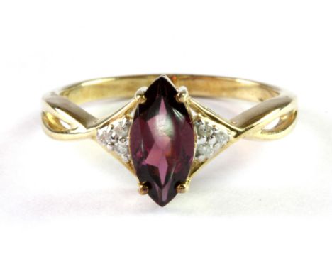 A 9ct yellow gold ring set with a marquise cut tourmaline and diamonds, (N.5).