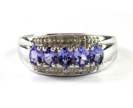 A 9ct white gold tanzanite and diamond set ring, (O.5).