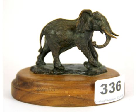 A small signed bronze figure of an elephant on wooden base, H. 8cm.