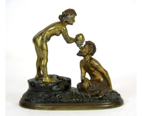 An Austrian cold painted bronze figure of Syrinx feeding grapes to Pan.