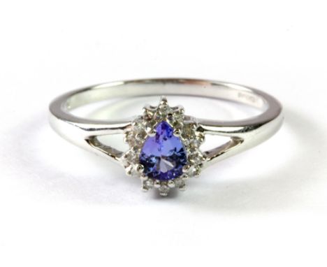 A 9ct white gold cluster ring set with a pear cut tanzanite and diamonds, (O.5).