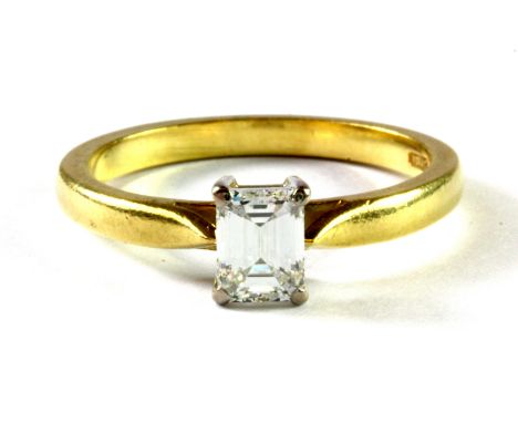 An 18ct yellow gold solitaire ring set with a baguette cut diamond, (P.5).