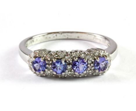 A 9ct yellow gold tanzanite and diamond set ring, (P.5).