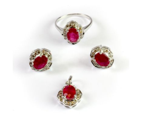 A 9ct white gold jewellery suite of pair of earrings, ring and pendant, set with oval cut rubies and diamonds, (N).