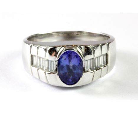 A heavy 14ct white gold (stamped 14k) tanzanite and diamond set ring, (U).