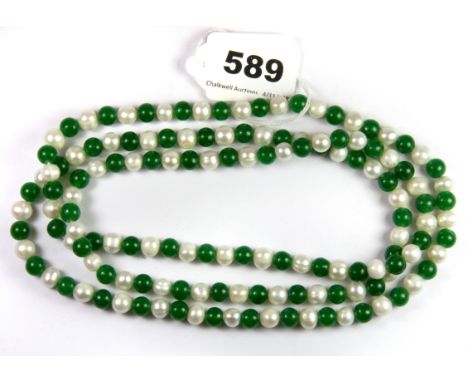 A single strand necklace of cultured pearls and jade, L. 110cm.